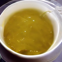 A close view of a bowl of golden soup